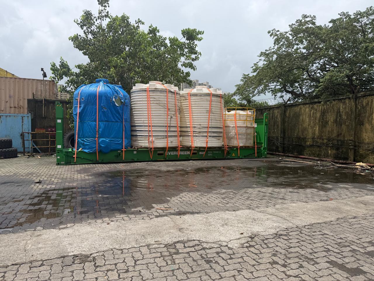 Moulded tanks lashed across an open-top flat rack